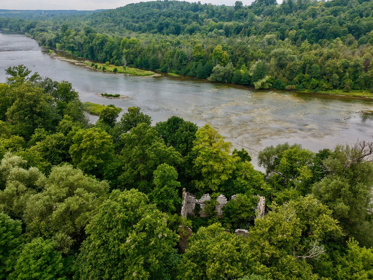 Aerial view of ruins tucked into trees near the Grand River